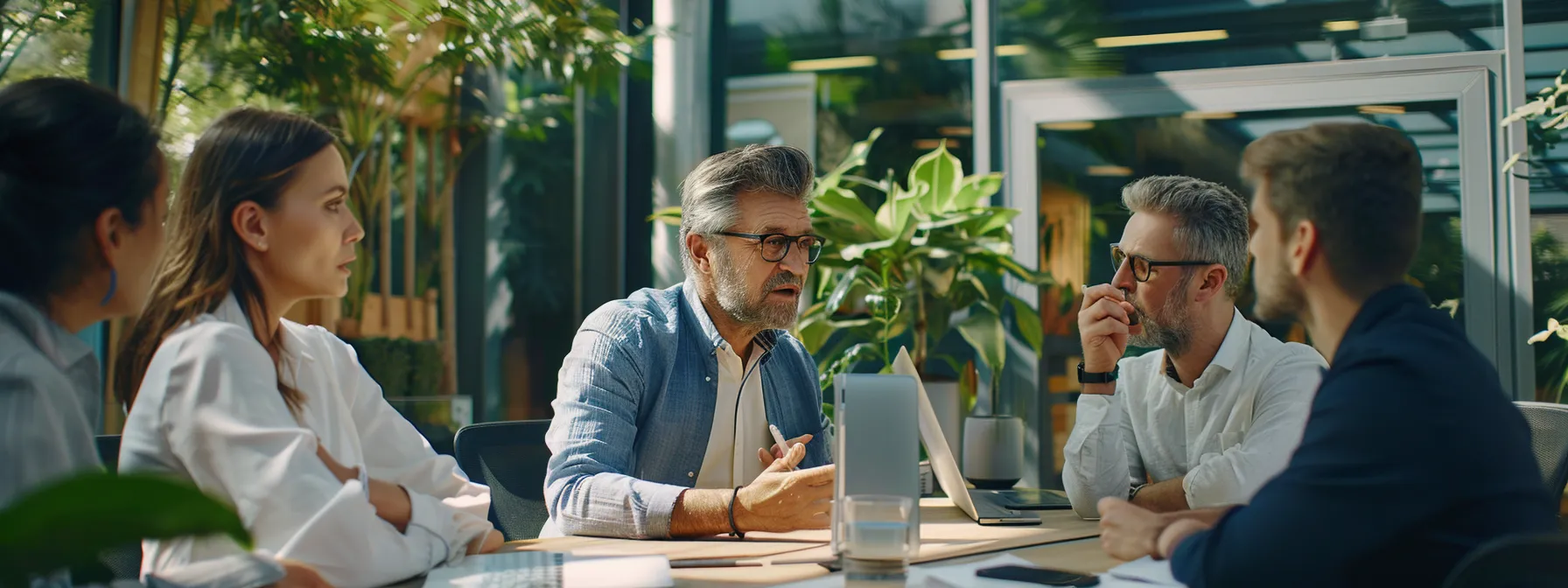 a team discussing and strategizing around a crm system on a computer screen.