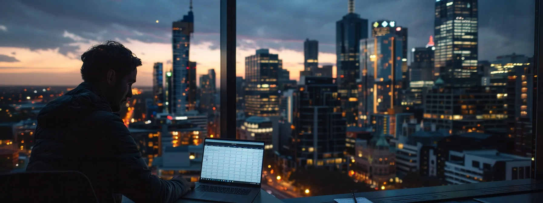 a person creating a social media content calendar on a laptop with a view of melbourne cityscape in the background.