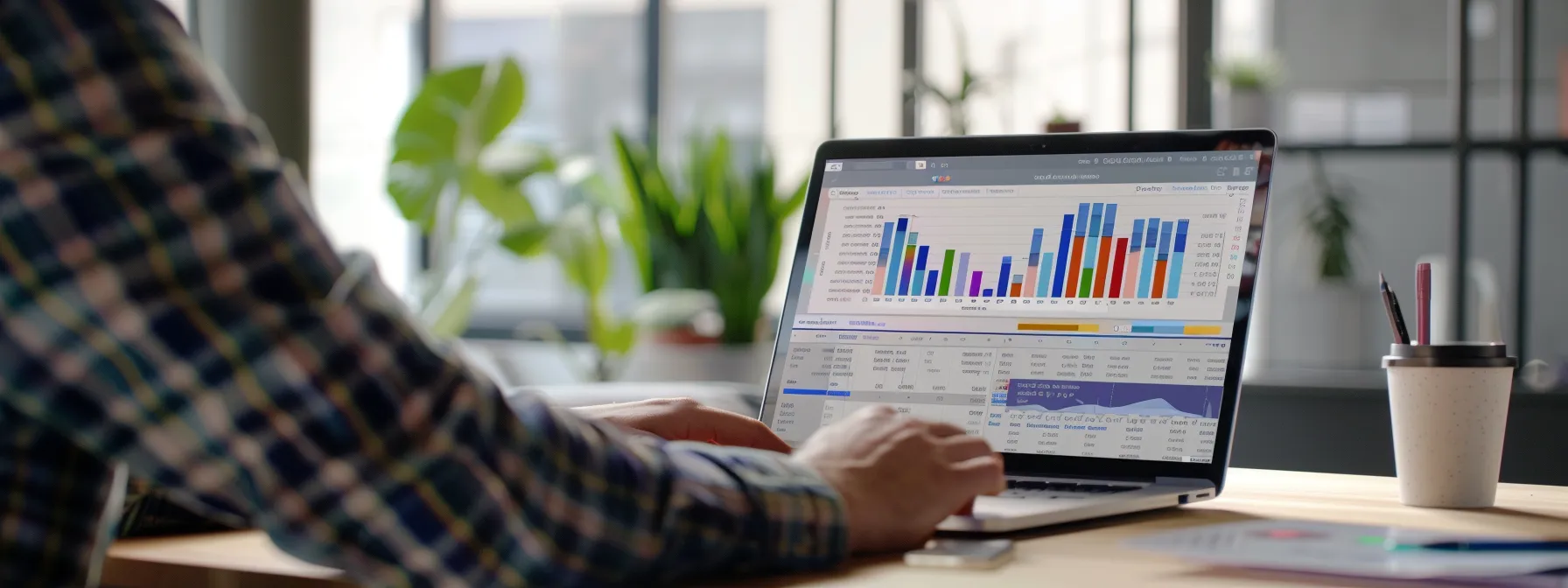 a person analyzing seo auditing tools on a laptop in a modern office setting.