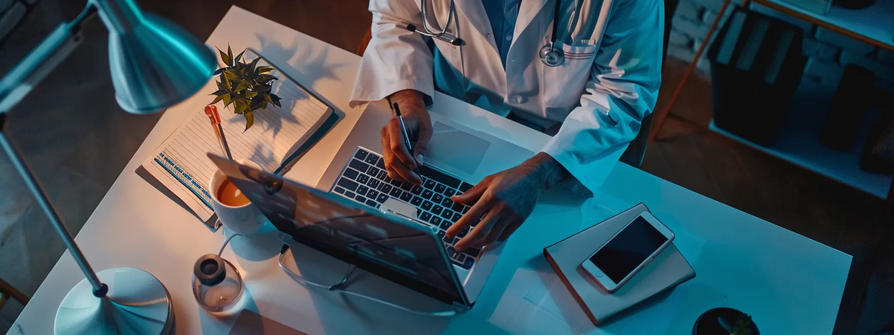 a doctor writing informative articles on a laptop to address patient queries.