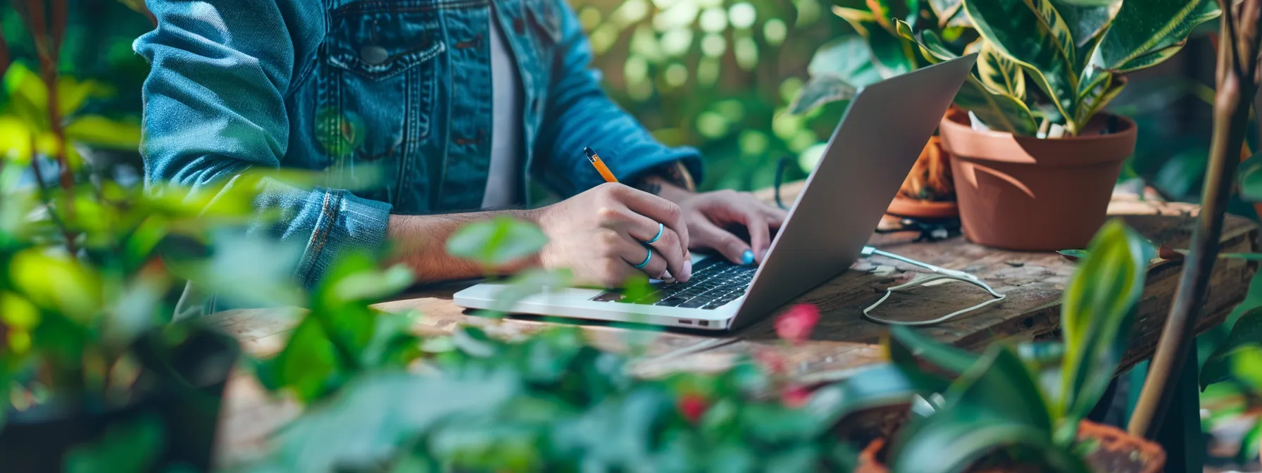 a person writing detailed landscaping tips and tricks on a laptop.