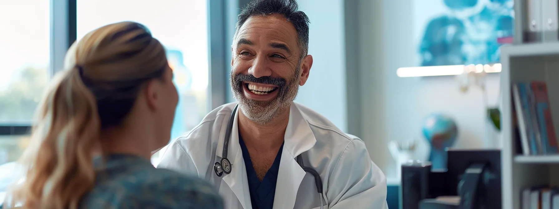 a hematologist smiling with a satisfied patient in a modern medical office.